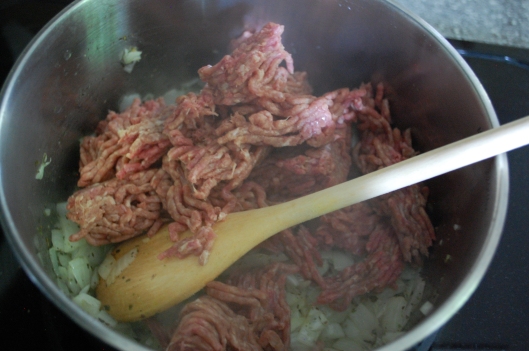 Adding the  beef to the mixture